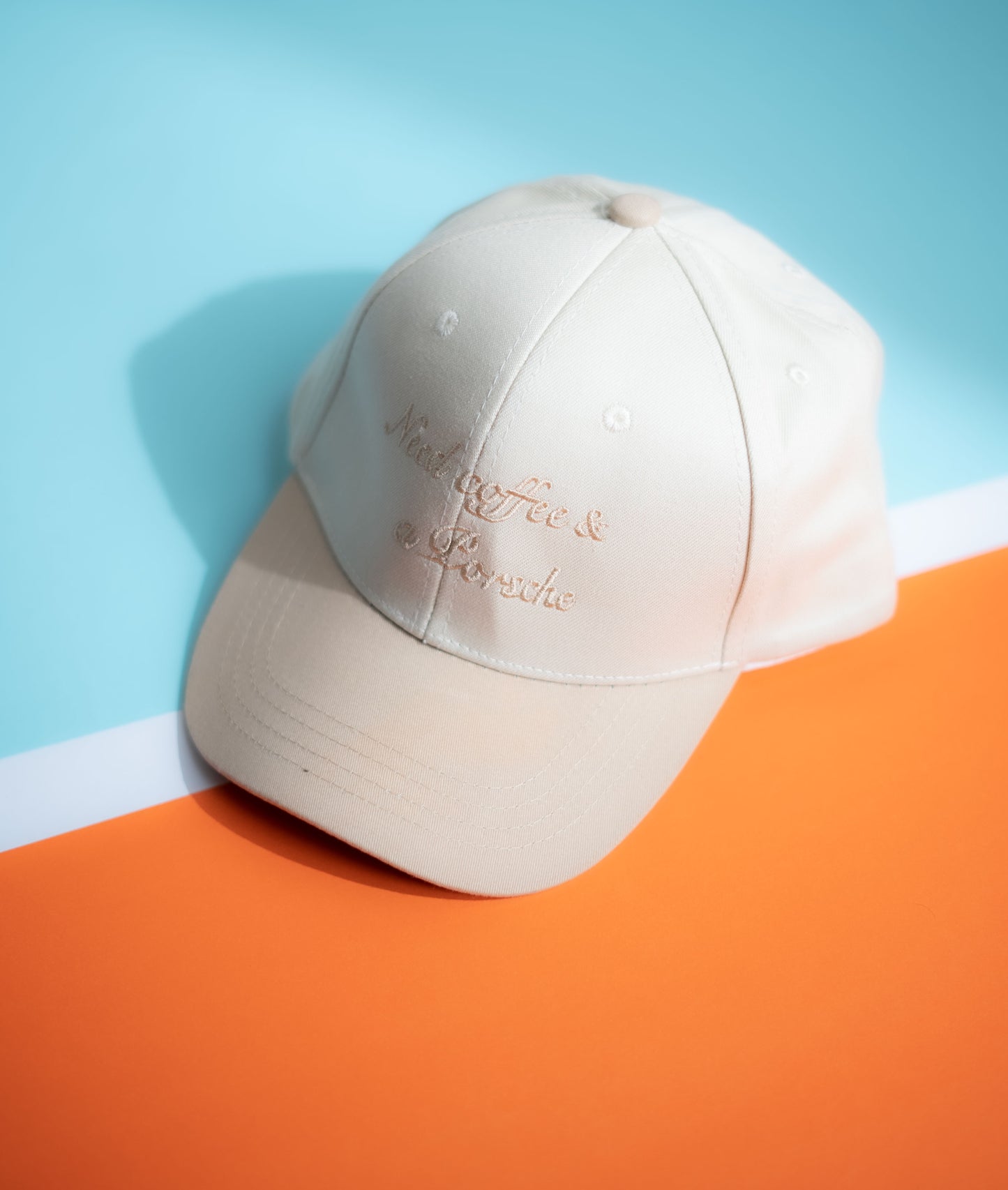 Beige cap with text on a blue and orange gradient background in Pakistan by Caps Nation