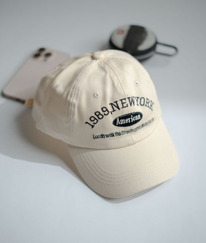 Beige cap with text on a light gray background in Pakistan by Caps Nation