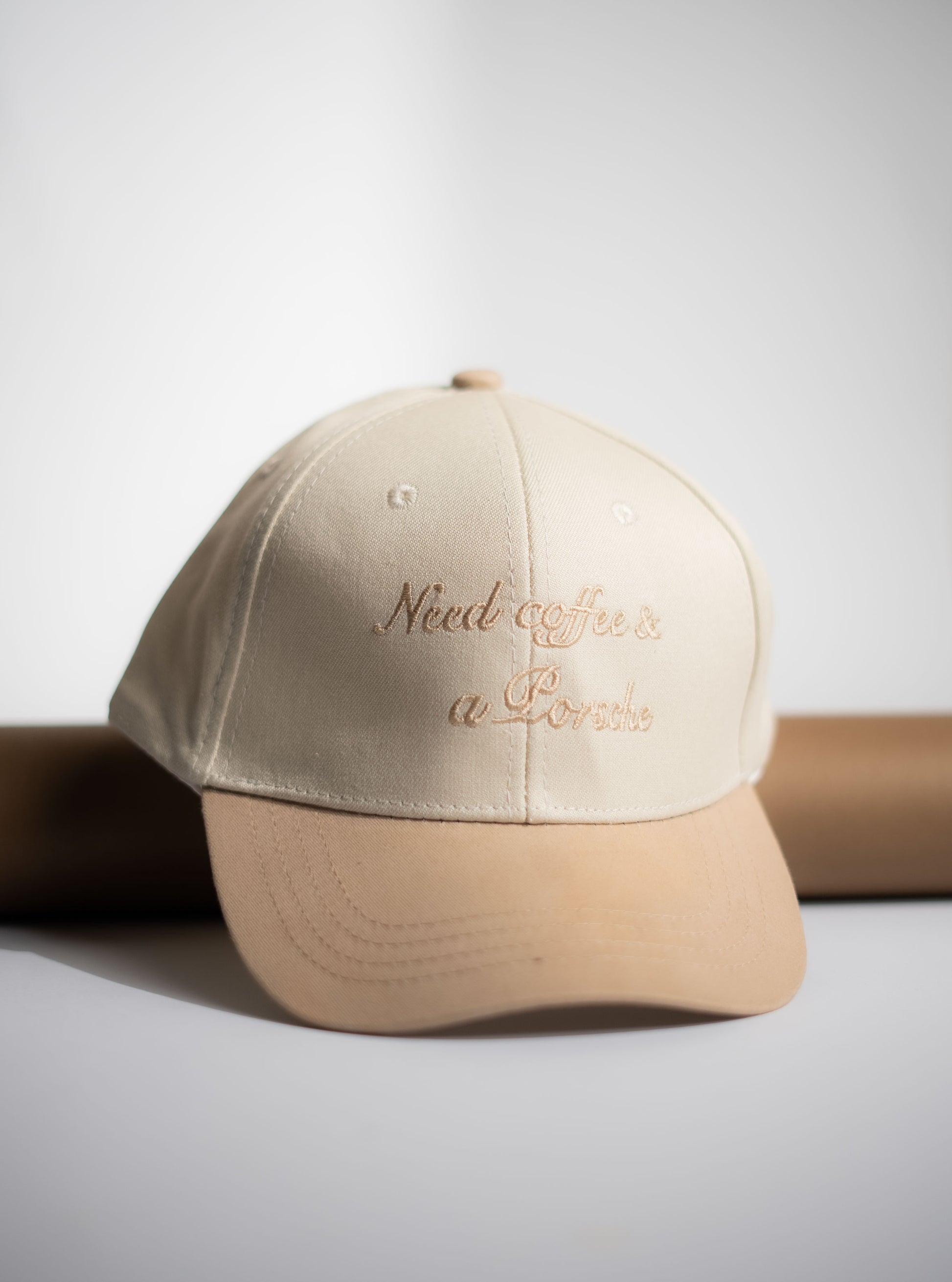 Beige cap with text on a light gray background in Pakistan by Caps Nation