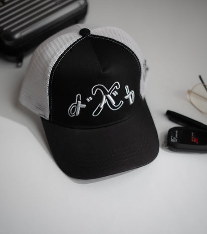 Black and white cap with a logo on a light surface in Pakistan by Caps Nation