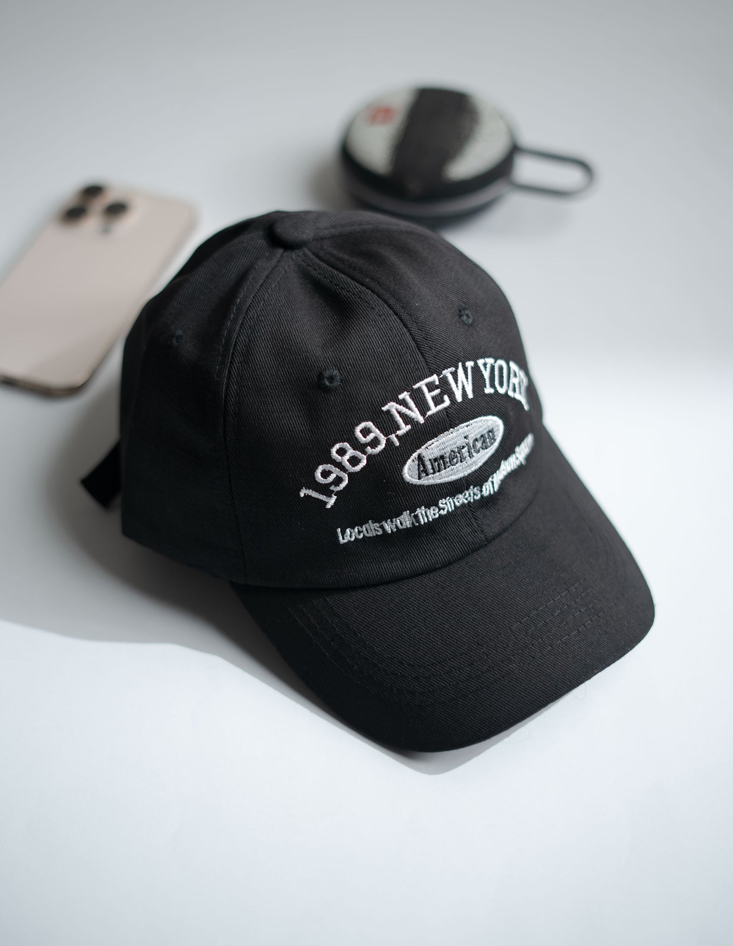 Black cap with text on a white surface in Pakistan by Caps Nation
