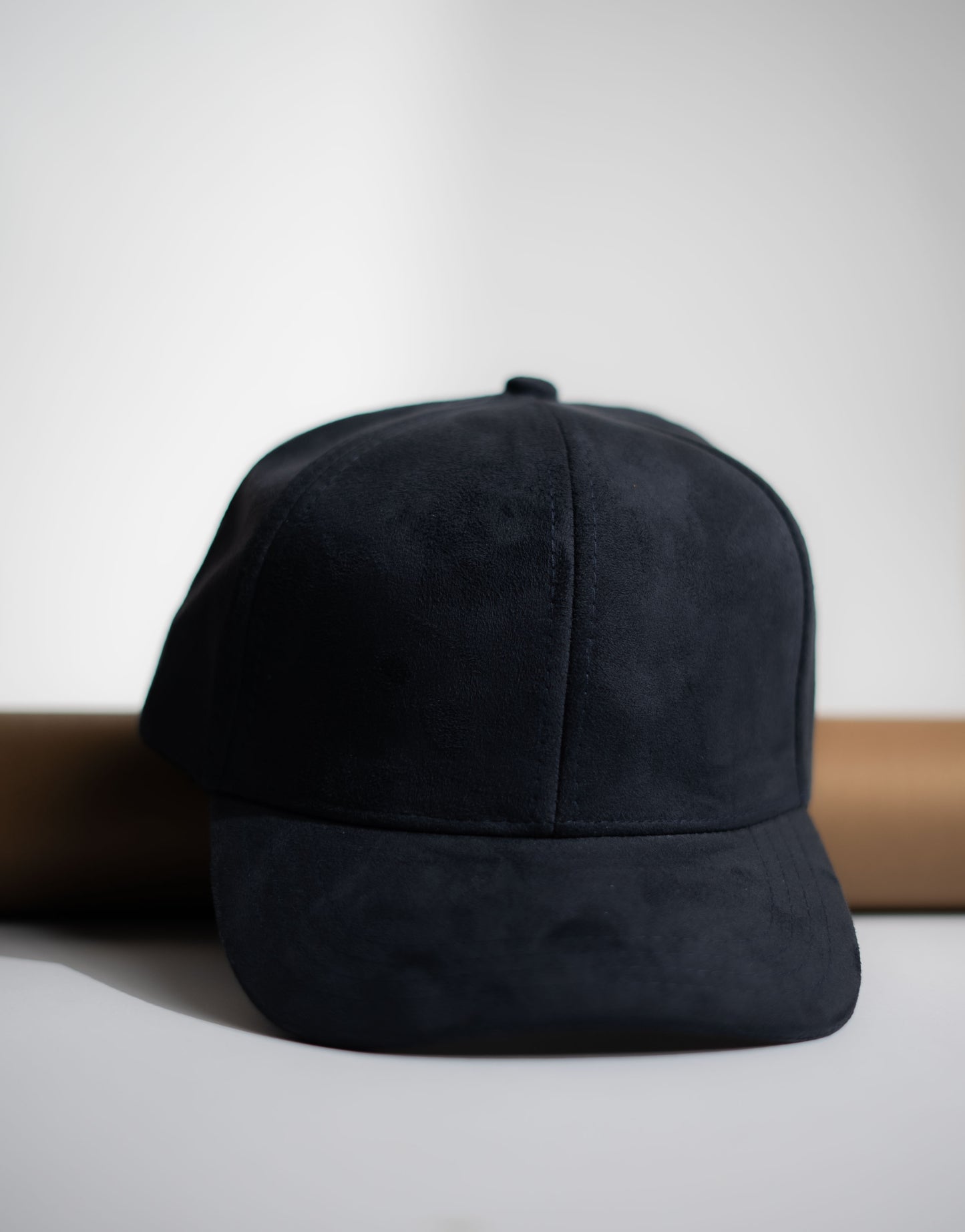 Black cap on a white surface with a neutral background in Pakistan by Caps Nation