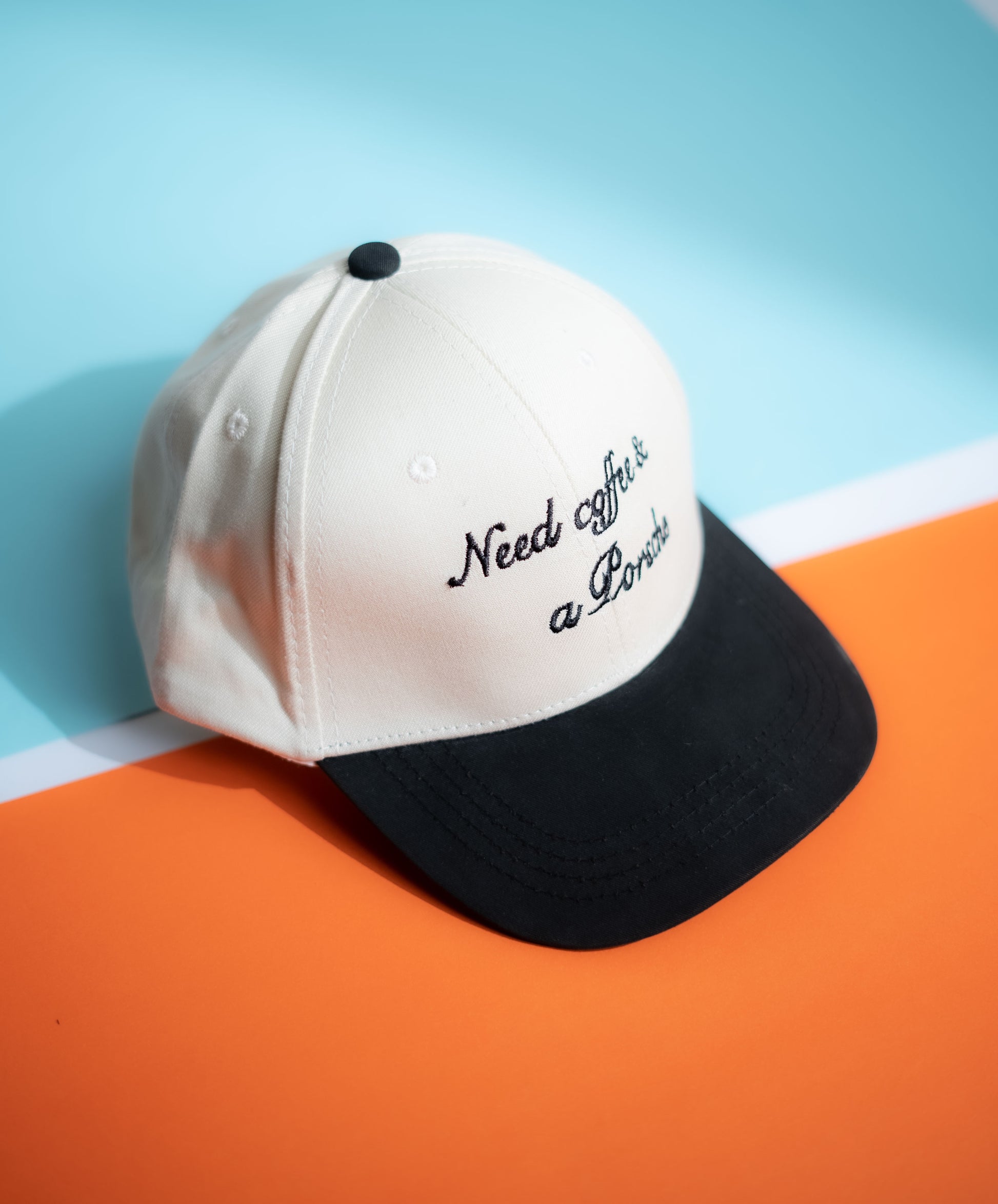 Cap with 'Need coffee & a pancake' text on a blue and orange  background in Pakistan by Caps Nation