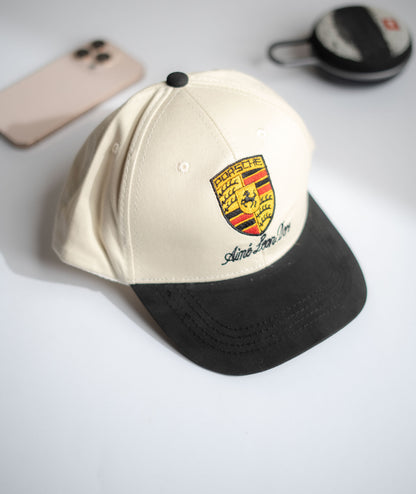Beige and black cap with a logo on a light gray surface in Pakistan by Caps Nation