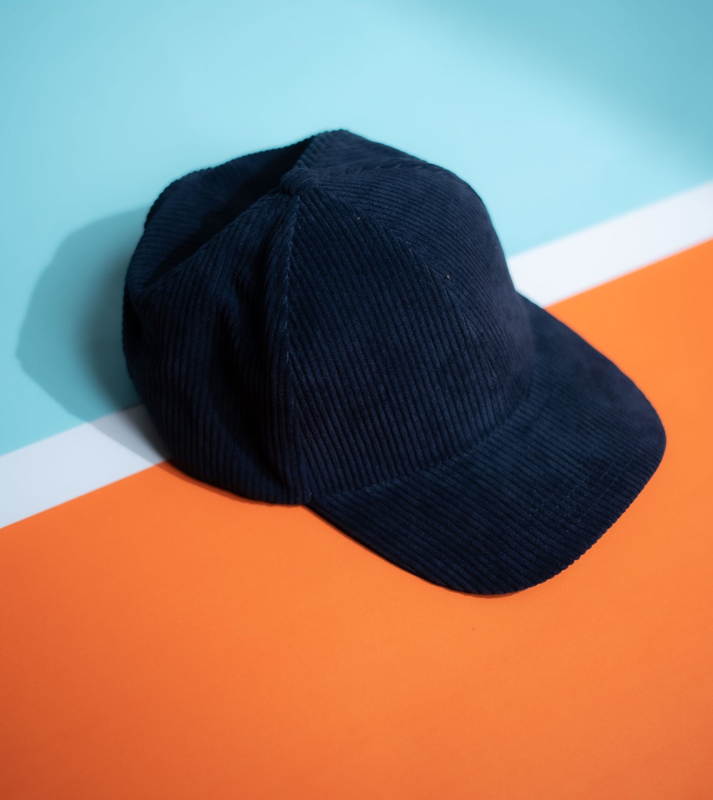 Navy blue cap on a colorful background in Pakistan by Caps Nation