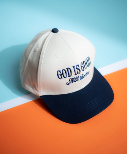 Cap with 'GOD IS GOOD All the Time' text on a blue and orange background in Pakistan by Caps Nation