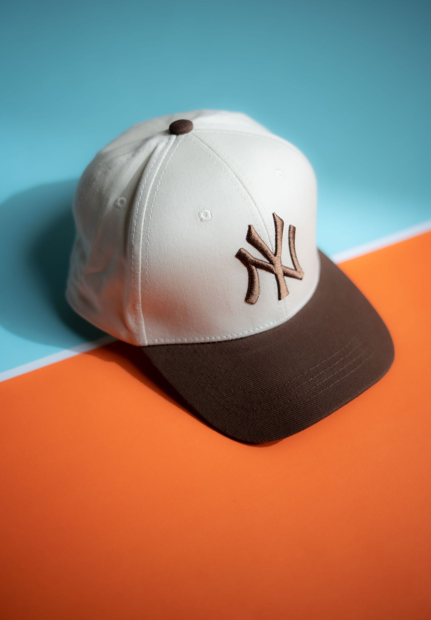 Baseball cap with a logo on an orange and blue background in Pakistan by Caps Nation