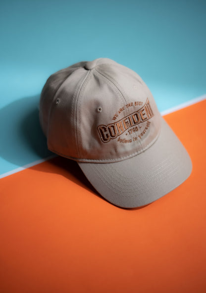 Beige cap with text on a blue and orange background in Pakistan by Caps Nation