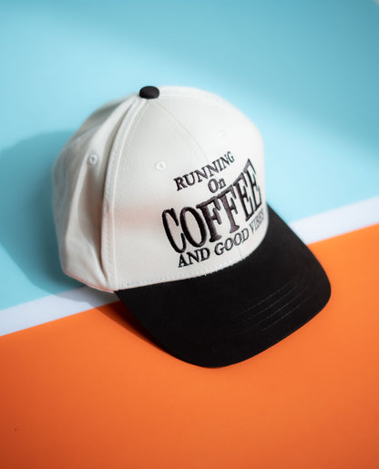 Cap with 'Running on Coffee and Good Vibes' text on a colorful background in Pakistan by Caps Nation