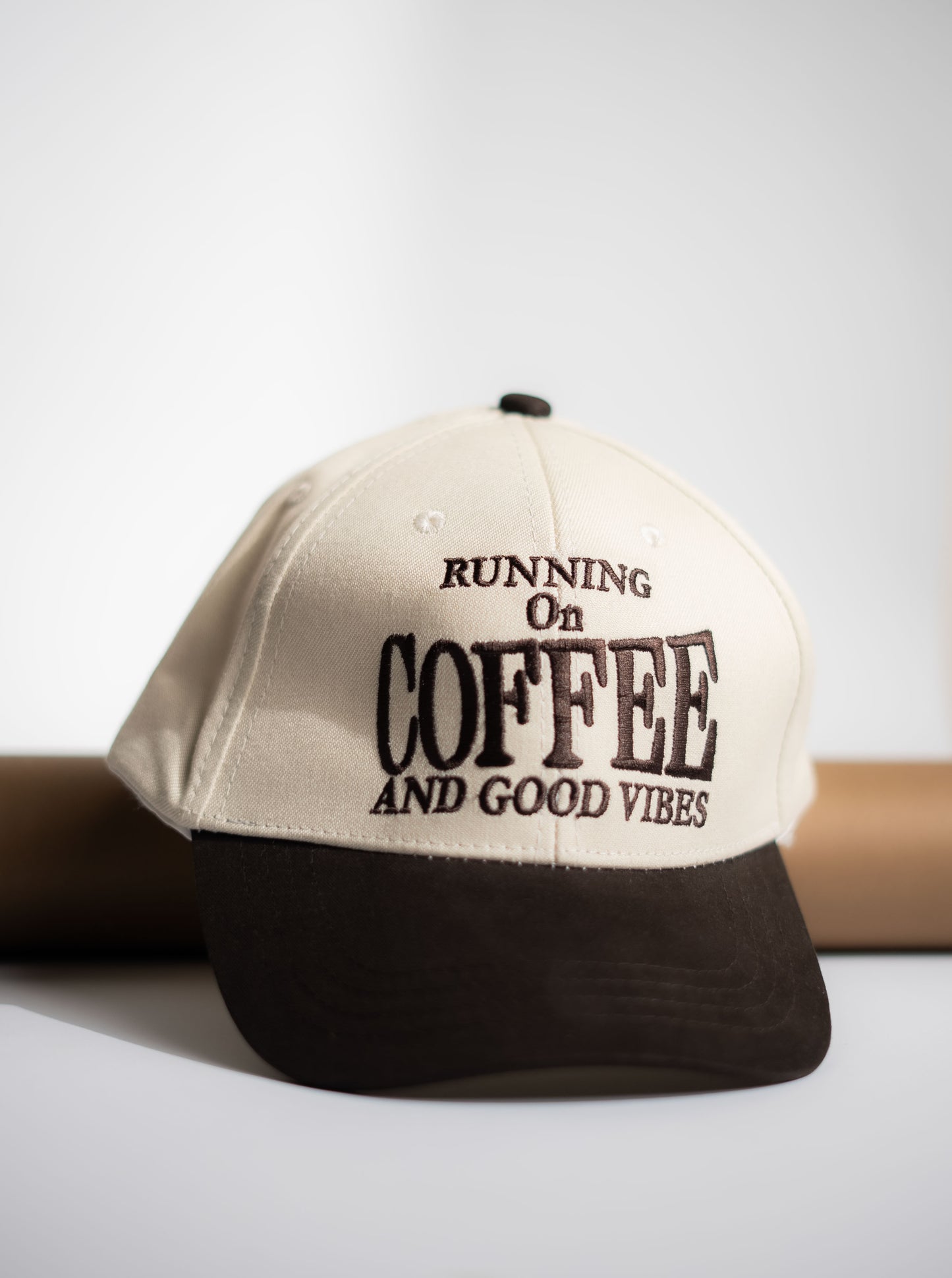 Cap with 'Running on Coffee and Good Vibes' text on a white background in Pakistan by Caps Nation