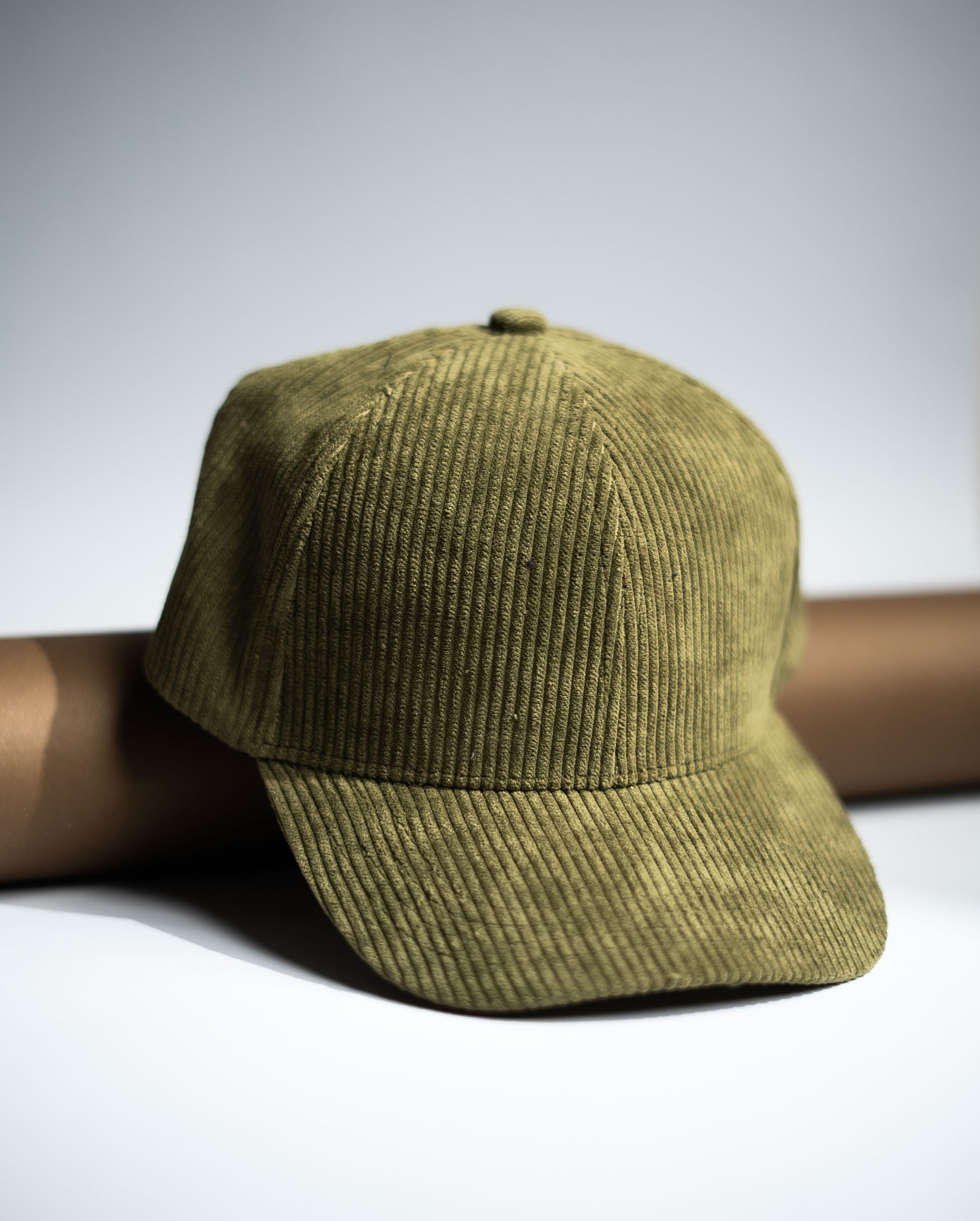 Green corduroy cap on a white background in Pakistan by Caps Nation