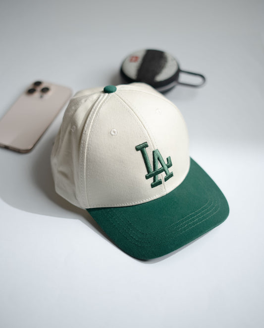 Baseball cap with green and white design on a light gray surface in Pakistan by Caps Nation