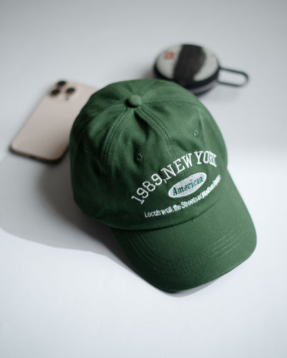 Green cap with text on a light gray background in Pakistan by Caps Nation
