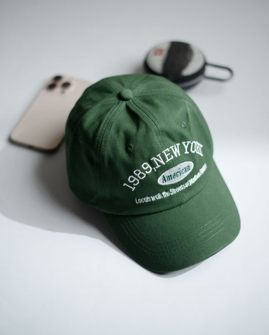 Green cap with text on a light gray background in Pakistan by Caps Nation