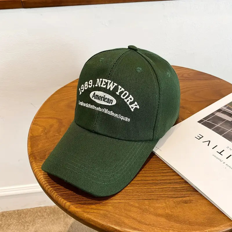 Green cap with text on a wooden table in Pakistan by Caps Nation