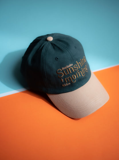 Two-tone cap with 'Sunshine mornings' text on a blue and orange background in Pakistan by Caps Nation