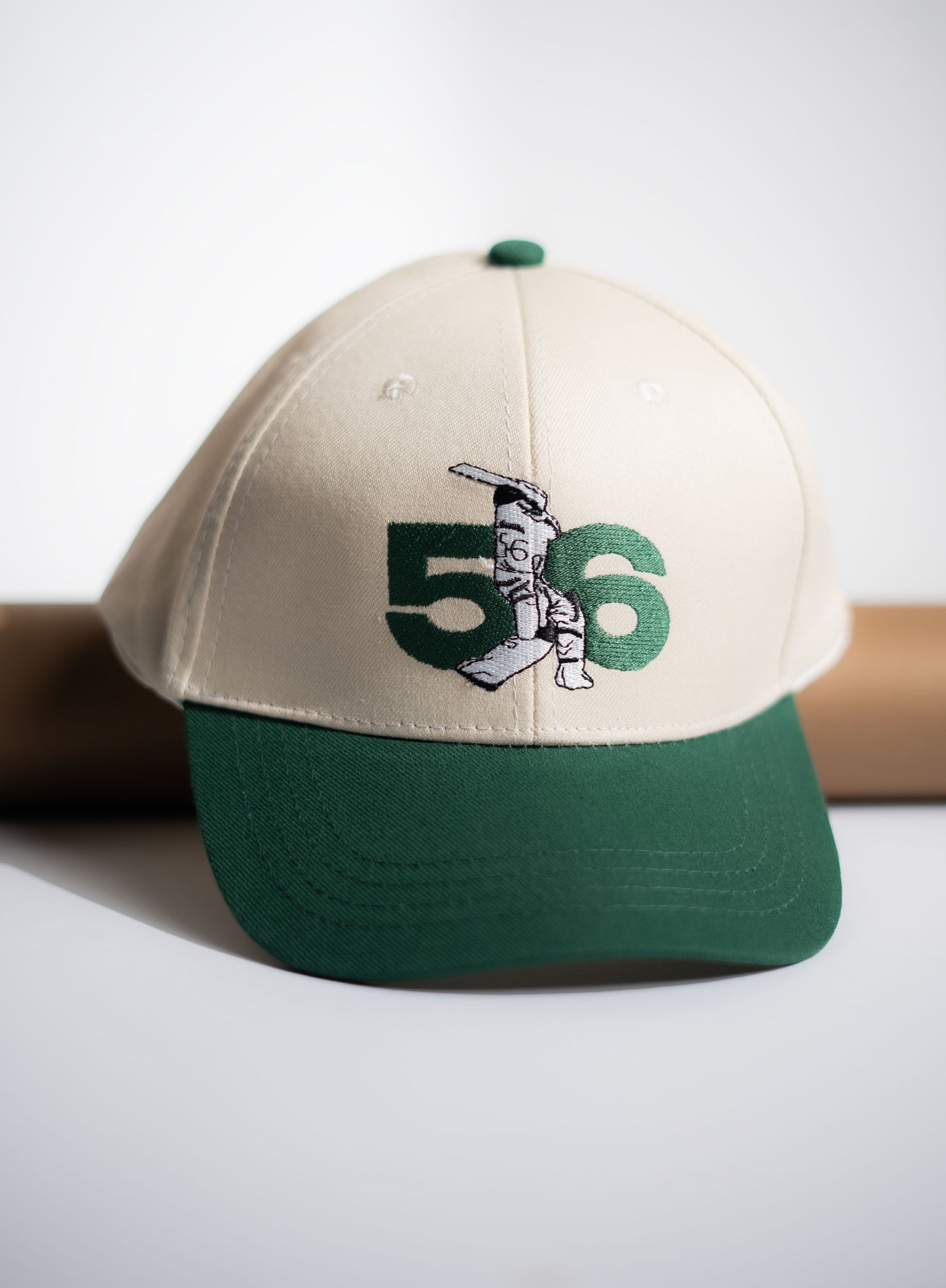 Beige and green cap with number 58 design on a white background in Pakistan by Caps Nation