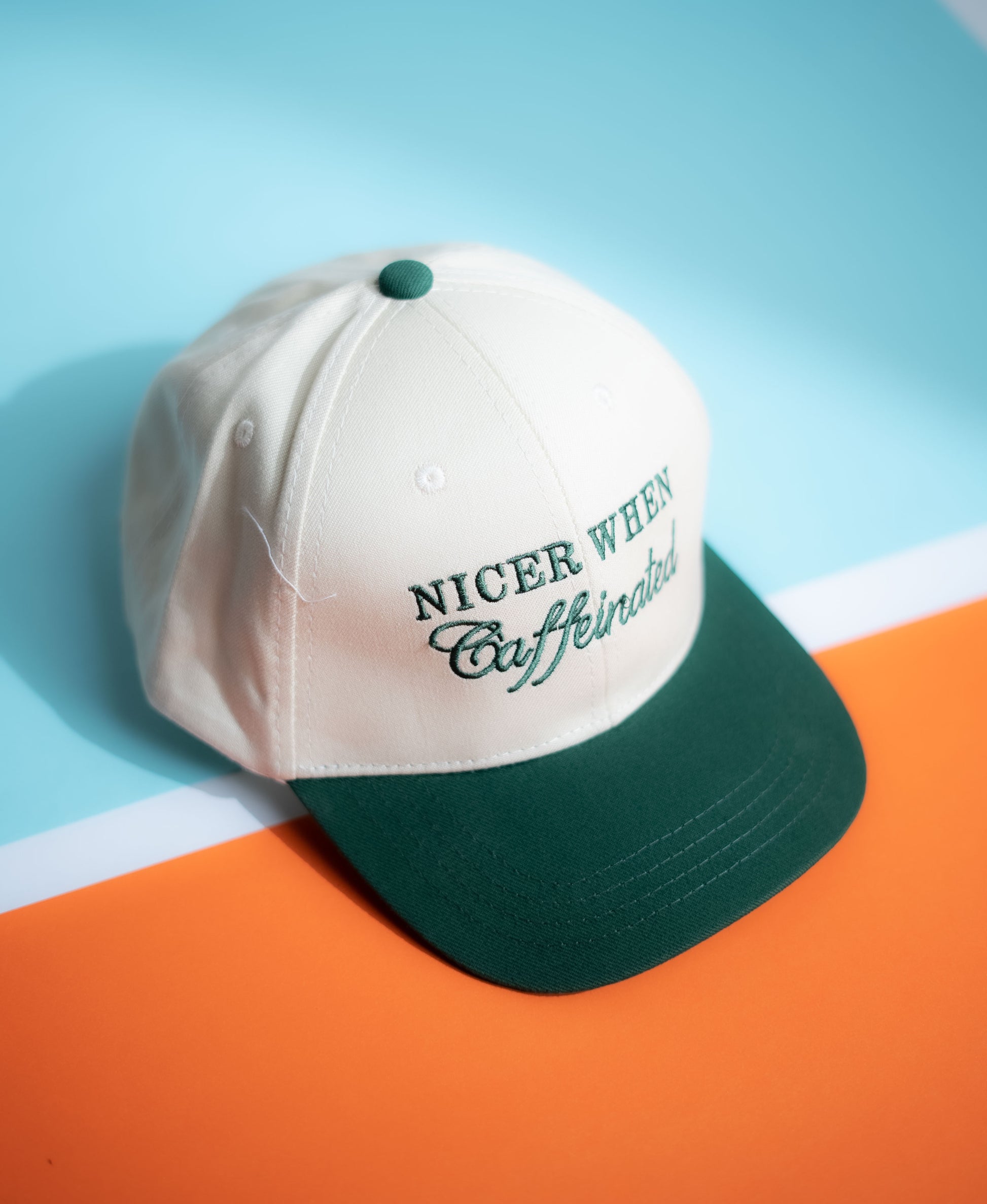 Cap with 'Nicer When Caffeinated' text on a blue and orange gradient background in Pakistan by Caps Nation