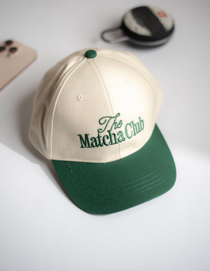 Beige and green cap with 'The Matcha Club' text on a light background in Pakistan by Caps Nation