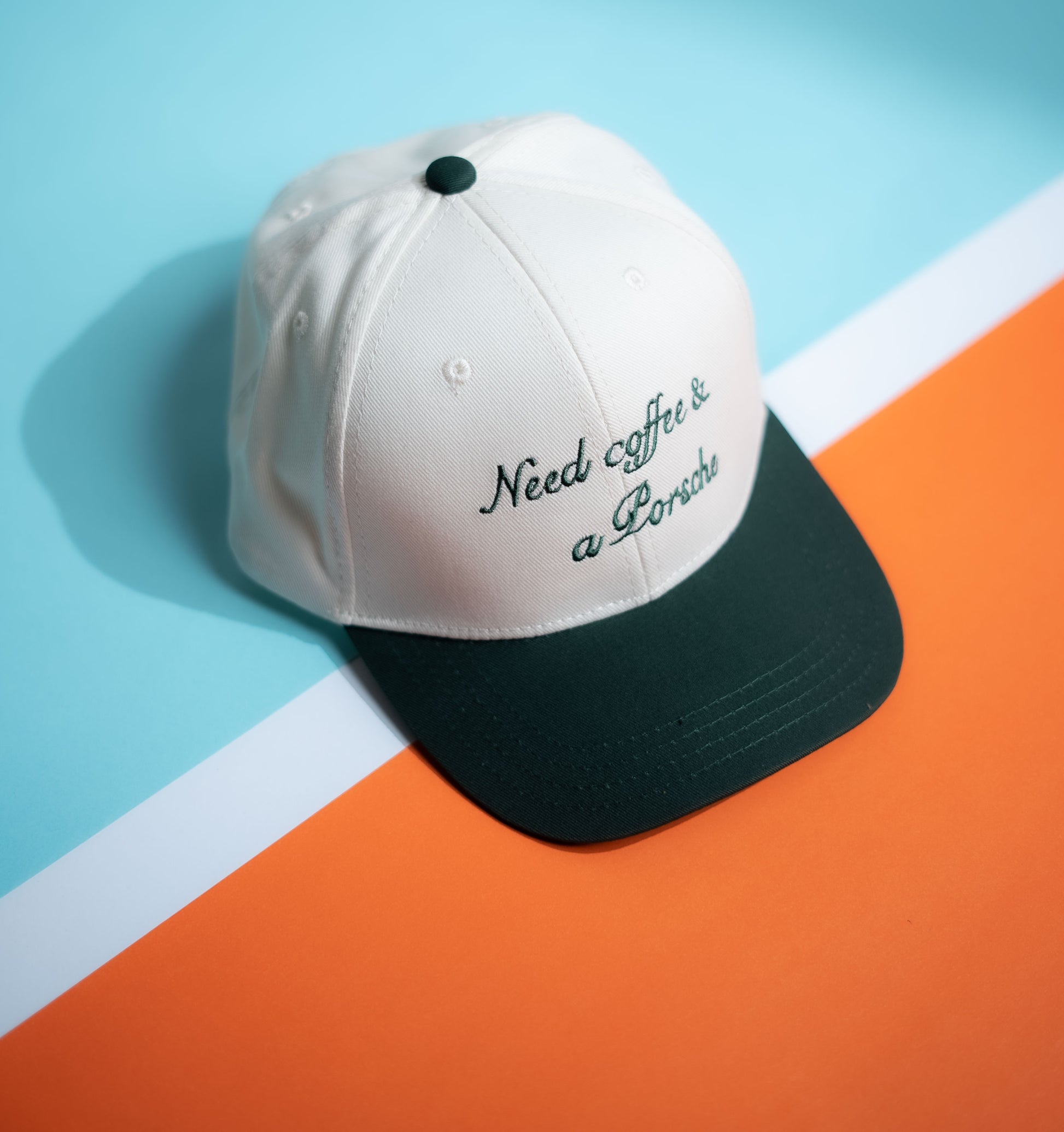 Cap with 'Need coffee & a Porsche' text on a neutral background in Pakistan by Caps Nation