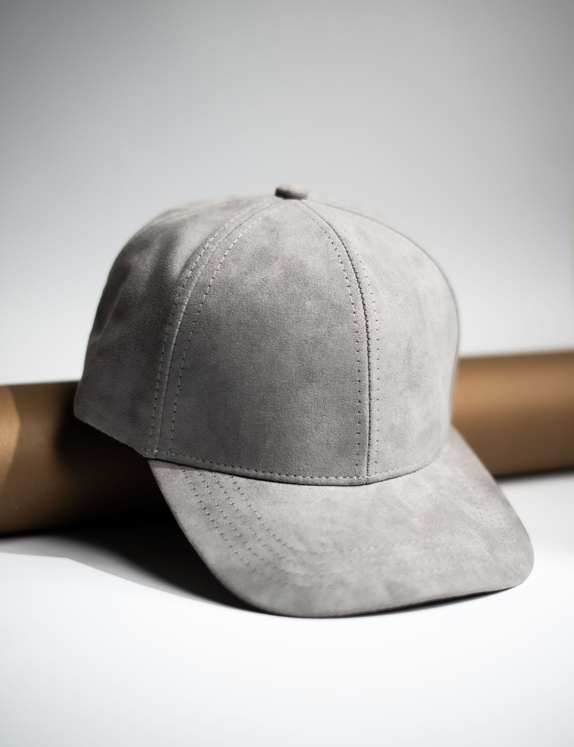 Gray suede cap on a light gray background  in Pakistan by Caps Nation
