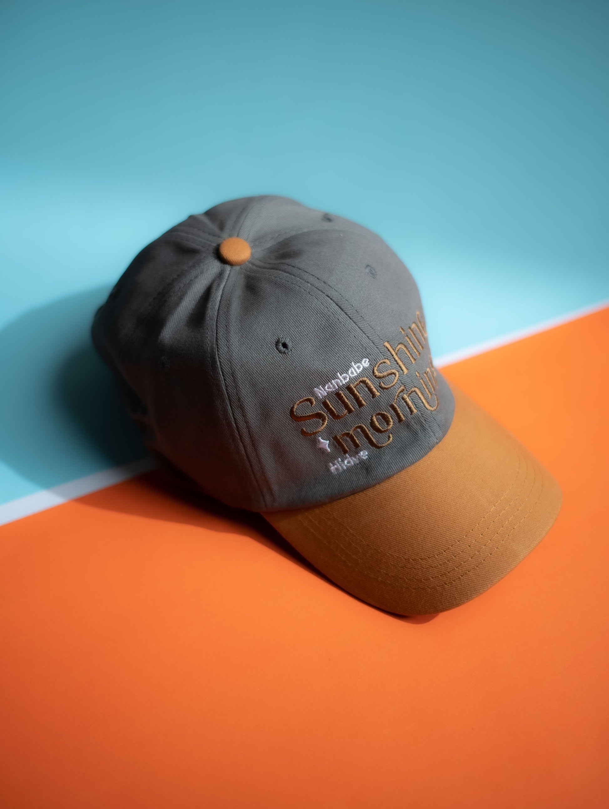 Gray and brown cap with 'Sunshine Mom' text on a blue and orange background in Pakistan by Caps Nation