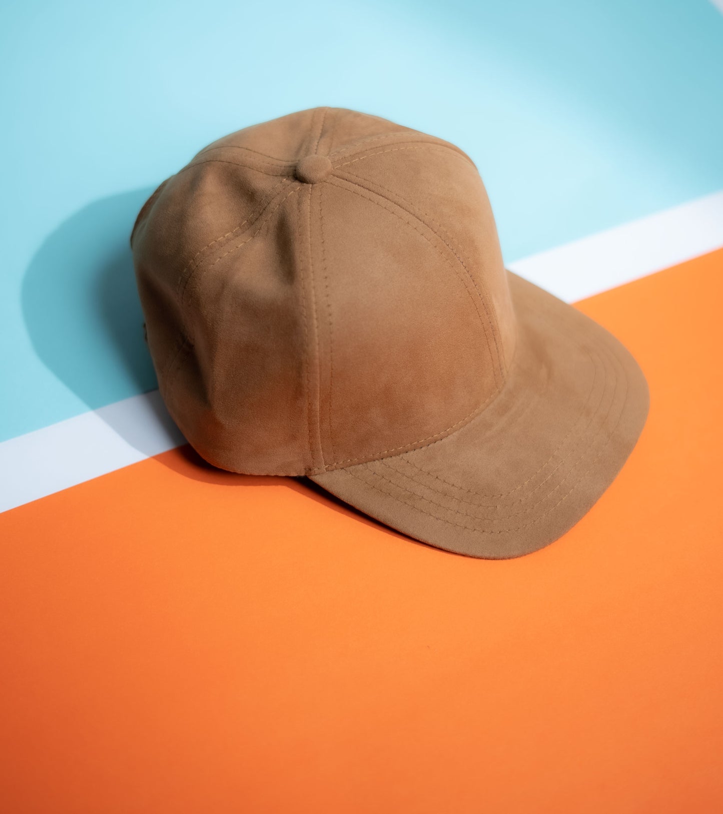 Brown cap on a colorful geometric background in Pakistan by Caps Nation