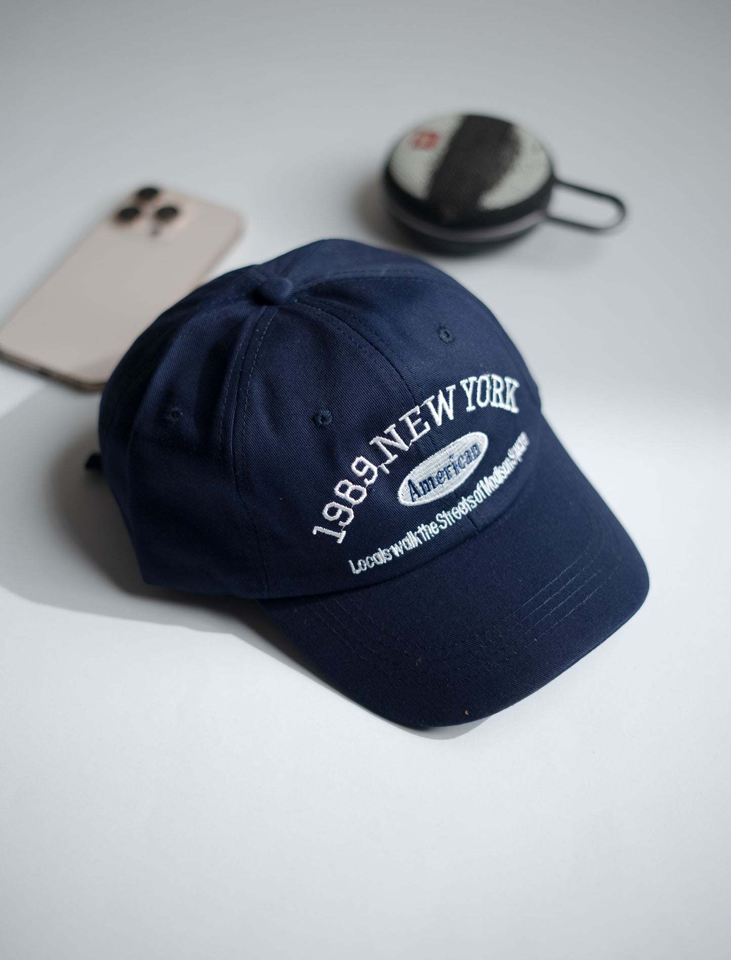 Navy blue cap with '1989 New York' text on a light gray surface in Pakistan by Caps Nation