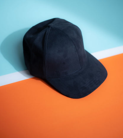 Black cap on an orange and blue background in Pakistan by Caps Nation