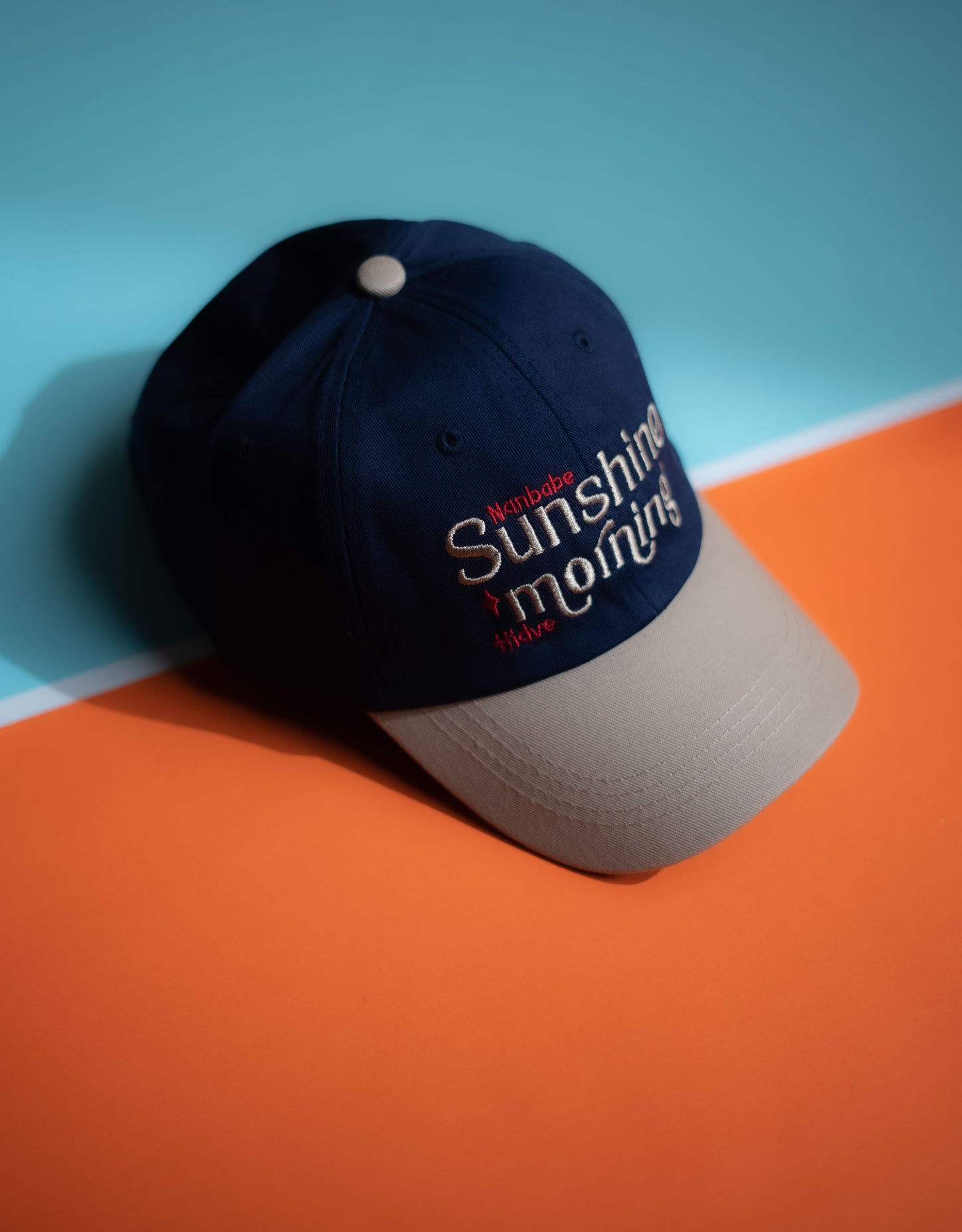 Navy blue cap with 'Sunshine & Rainbows' text on a two-tone background in Pakistan by Caps Nation