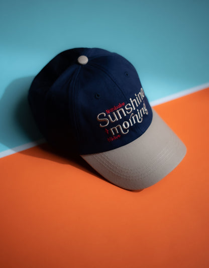 Navy blue cap with 'Sunshine & Rainbows' text on a two-tone background in Pakistan by Caps Nation