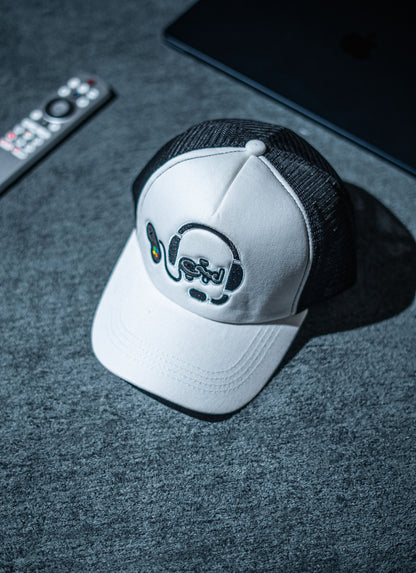 White cap with black brim and logo on a dark surface in Pakistan by Caps Nation